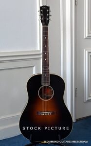 image of Model: Jackson Browne Siganture Body Type: Round Shoulder Top: Adirondack Red Spruce Back and Sides: Farmed English Walnut Construction: 1930s Gibson Jumbo body style, Body depth: 4.55" / 116 mm at head block, 4.83" / 123 mm at tail block Binding: Multi-ply Top Binding, Single Ply Back Binding Rosette: Traditional 3 ply Bracing: Scalloped Red Spruce Top Bracing: (1930's X-Braced) Neck: 1-piece Mahogany Profile: Modified "V" Profile Thickness: 1.805" at Nut Truss Rod: Single Action Joint: Compound Dovetail Construction: Joint at 12th Fret Adhesive: Hide Glue Fingerboard: Rosewood Frets: 21 Scale Length: 24 3/4" Radius: 12" Fret Wire: Gibson Montana standard Inlays: Abalone slotted diamonds on fingerboard Nut: Bone Width: 1.805" / 46 mm Headstock: Traditional Tapered 1930's Gibson Inlay: Mother of Pearl Gibson Peghead logo Truss Rod Cover: Black Tuning Keys: Gold Waverly with Ivoroid buttons Bridge: Rosewood Type: Traditional Rectangle with open ended saddle slot Bridge Pins: Traditional Pickguard: Firestripe Pick Guard Strap Buttons: End Pin Strap Button Finish: Sealer: Hand Sprayed Nitrocellulose Lacquer Electronics: Trance Audio Amulet True Stereo Case: Gibson Custom